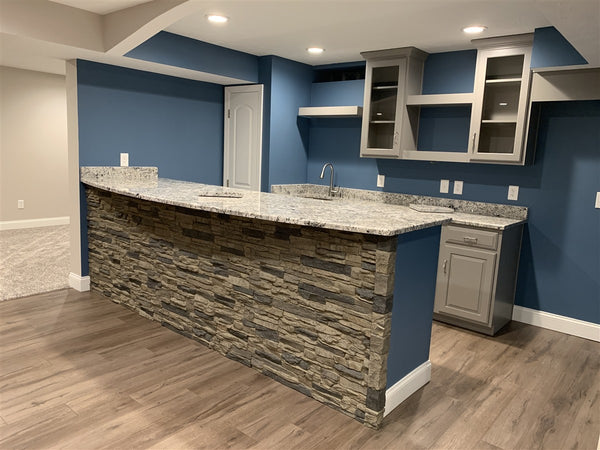 Lightning Ridge faux stone panel in Grey Fox – living room and accent wall installed by a contractor